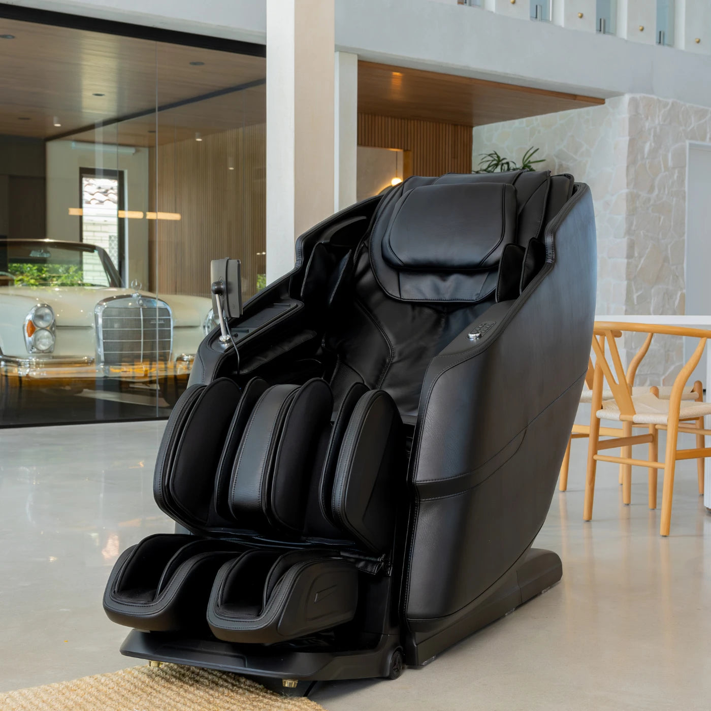 Alpha X full-body massage chair in jet black leather with deep tissue massage and a heated seat.