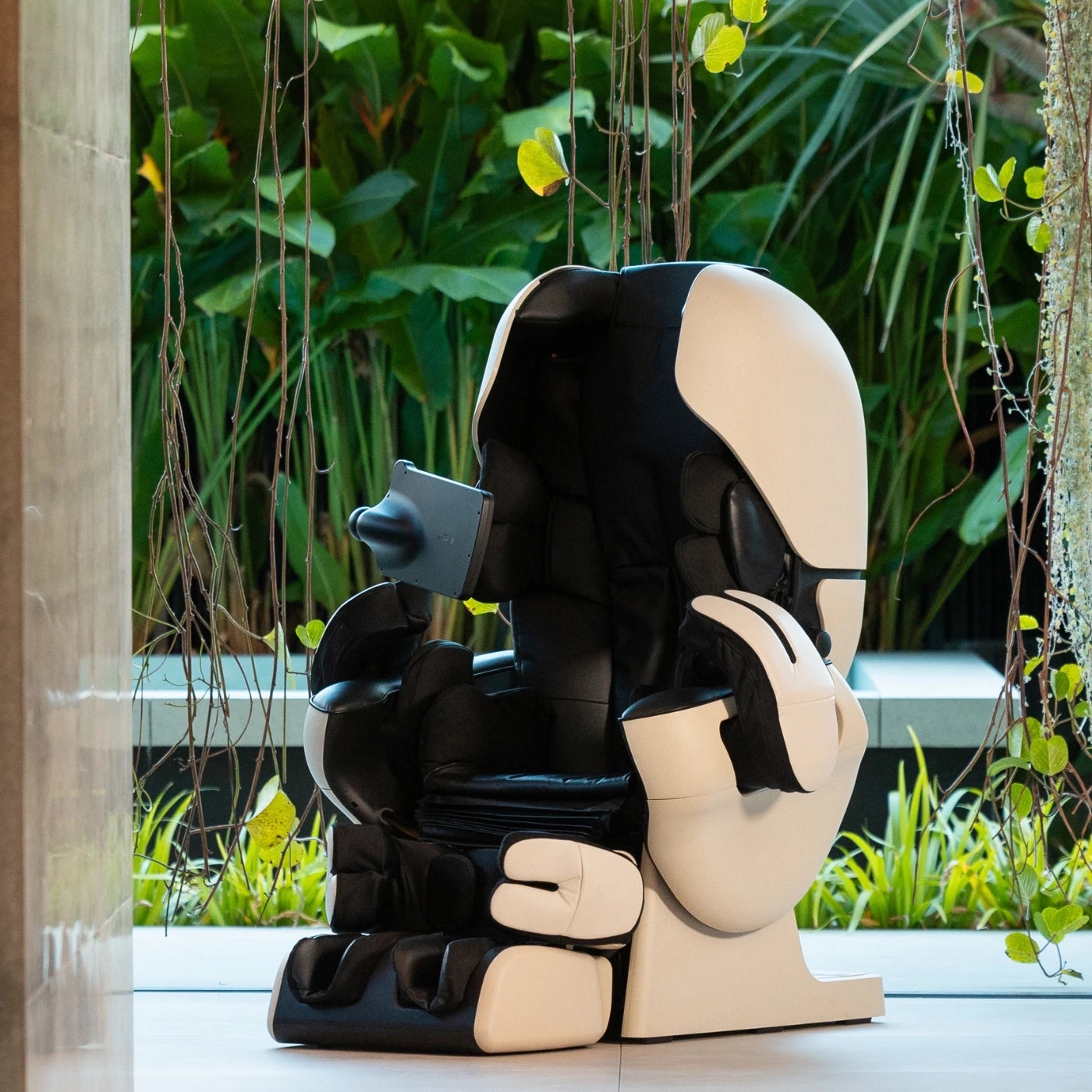 ROBO massage chair in black and white with a curved futuristic design, featuring AI-powered massage technology.